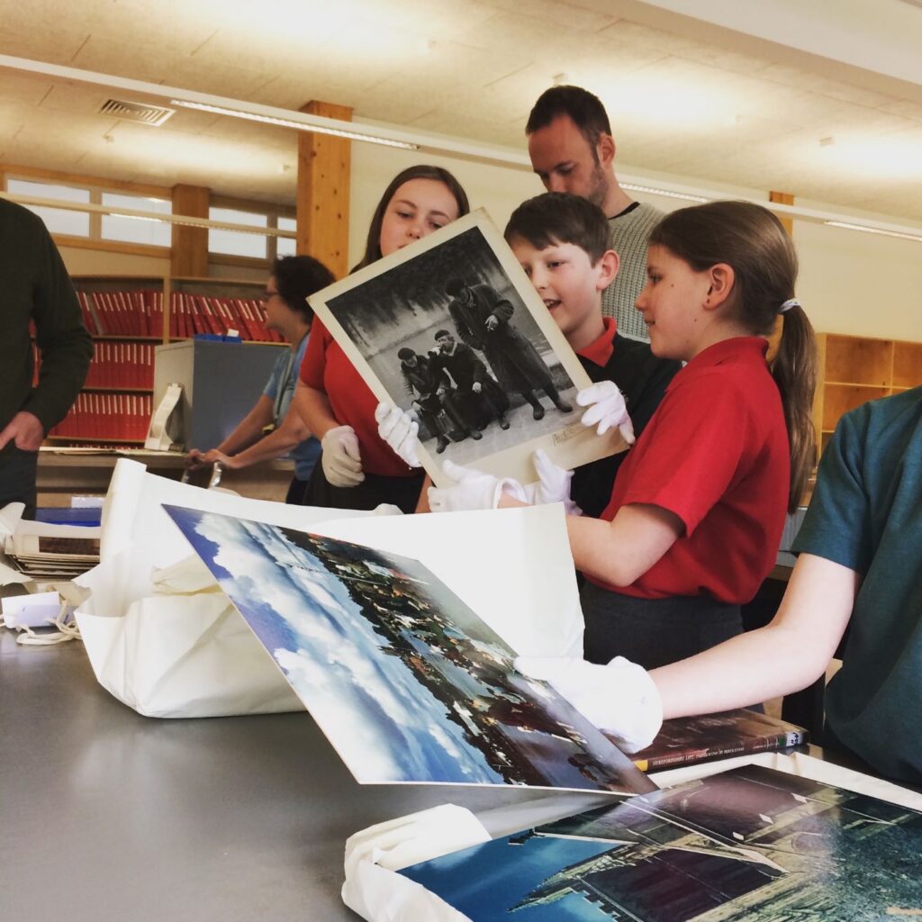 1543501313-School training 2018 pupils handle DE prints at archives – smiling 2