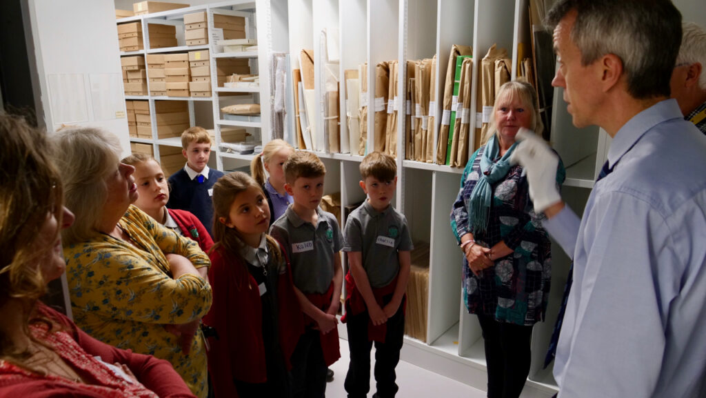 1568126094-School children explore the Derek Evans archives with Rhys Griffith
